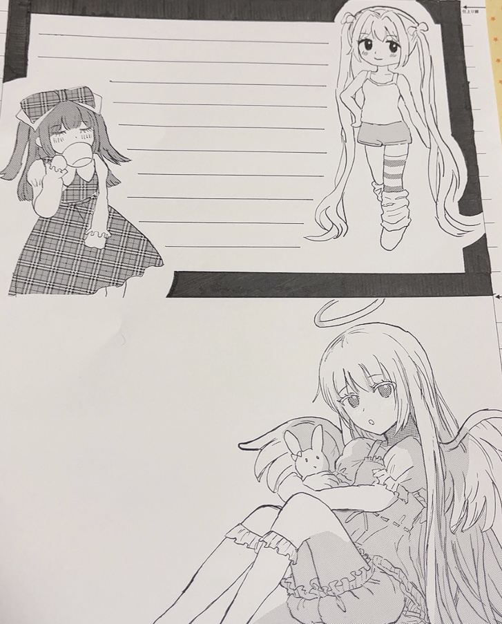少女3人のイラストが描かれている原稿用紙